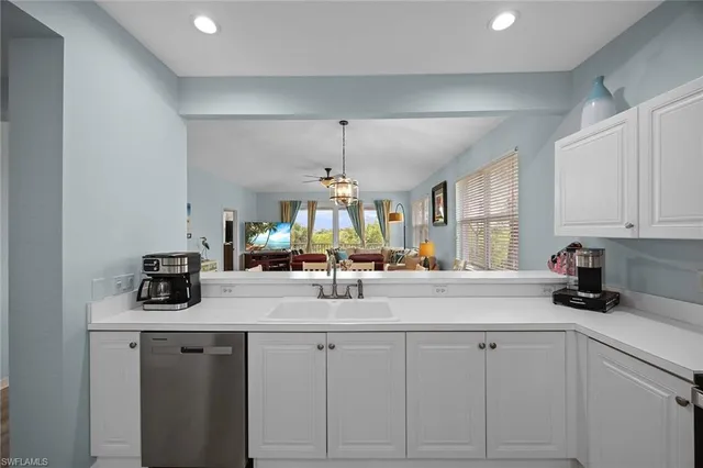 a kitchen with sink cabinets and window