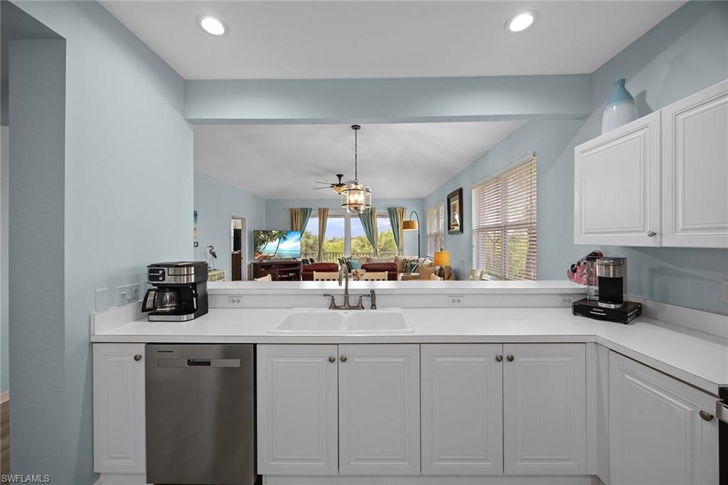 8365 Whisper Trace Way, Unit L204 Naples, FL 34114 - Photo 13 of 45 a kitchen with sink cabinets and window