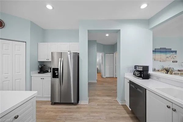 a kitchen with a refrigerator and a stove