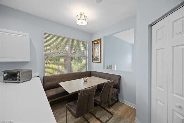 a view of a dining room with furniture and window