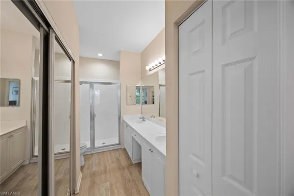 a bathroom with a sink a mirror and a shower