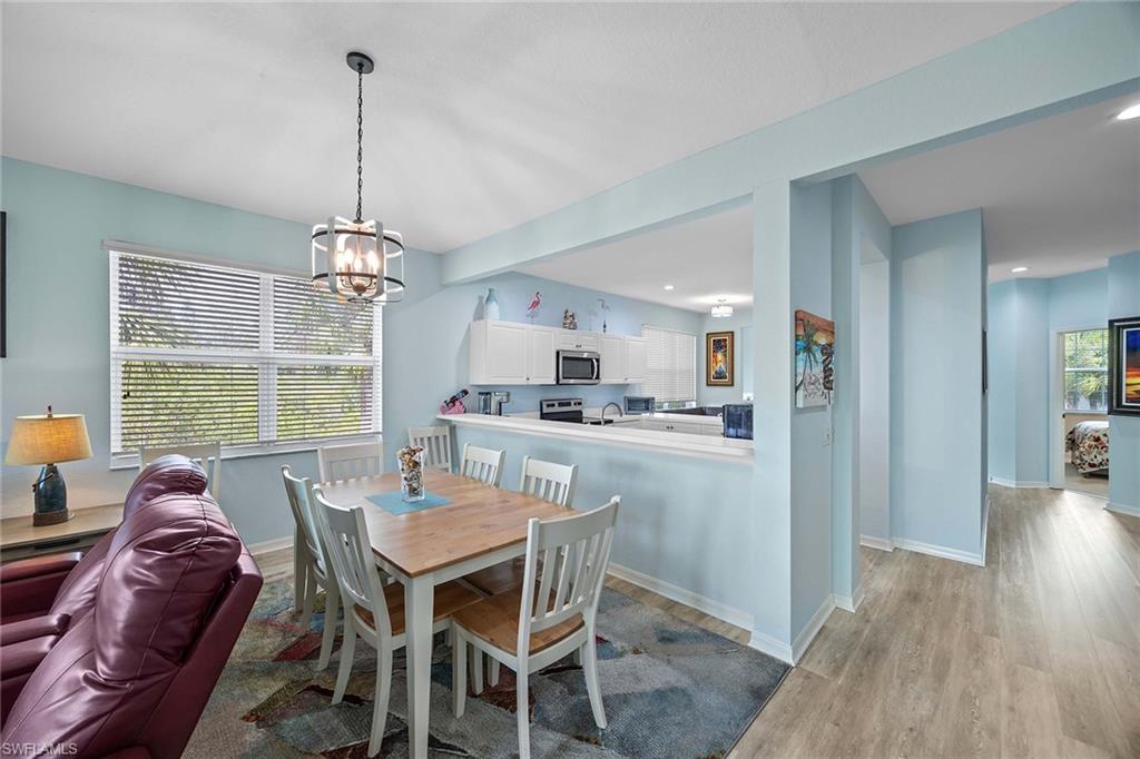 8365 Whisper Trace Way, Unit L204 Naples, FL 34114 - Photo 18 of 45 a view of a dining room with furniture window and wooden floor