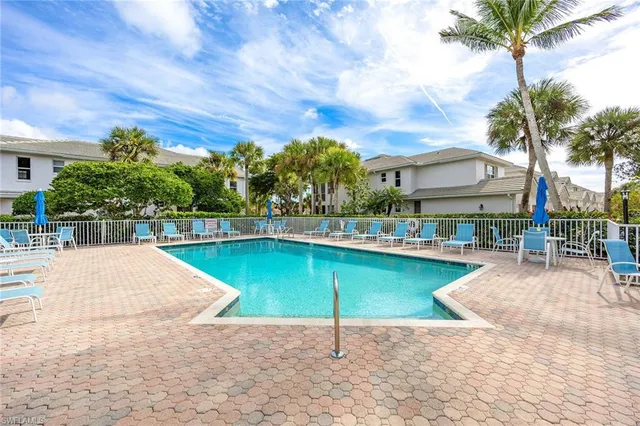 a view of a swimming pool with a table and chairs
