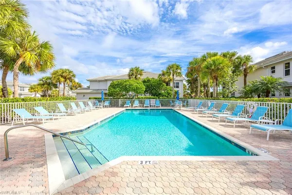 a view of a swimming pool with a lounge chairs