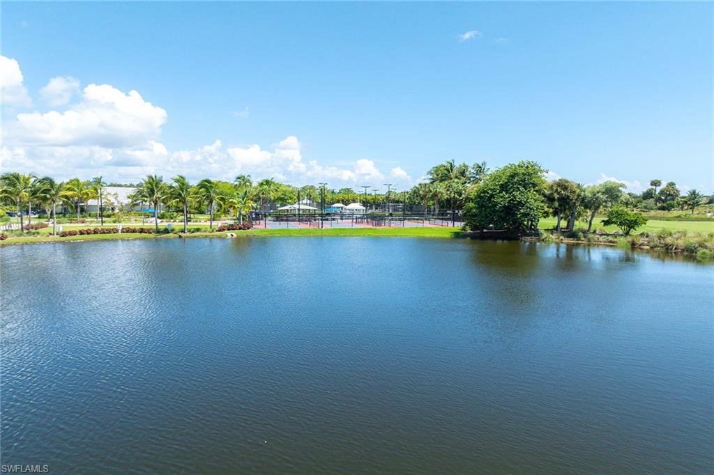 8365 Whisper Trace Way, Unit L204 Naples, FL 34114 - Photo 30 of 45 a view of a lake with houses in the back