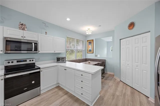 a kitchen with a sink stove and microwave