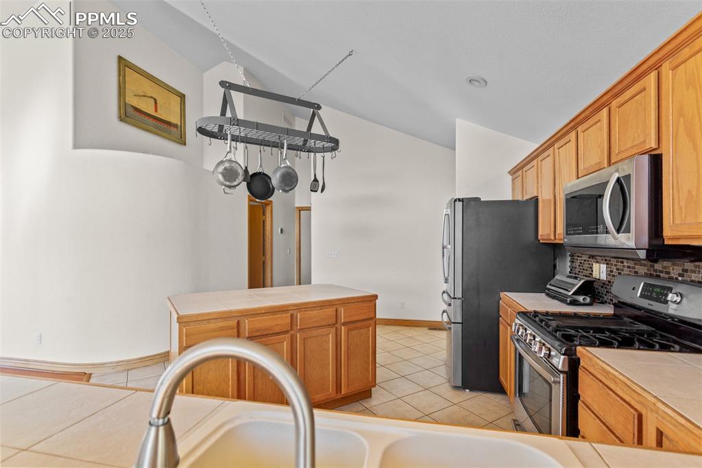 162 Ridge Top Drive Divide, CO 80814 - Photo 14 of 50 a kitchen with stainless steel appliances granite countertop a refrigerator a stove top oven a sink and dishwasher