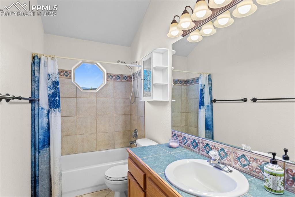 162 Ridge Top Drive Divide, CO 80814 - Photo 23 of 50 a bathroom with a granite countertop sink a toilet and shower