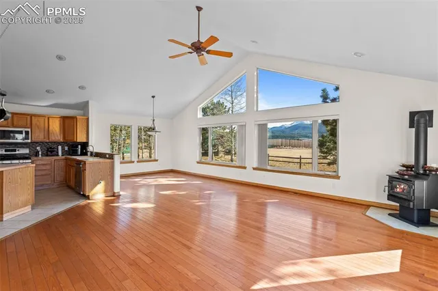 a view of an empty room with furniture and a kitchen