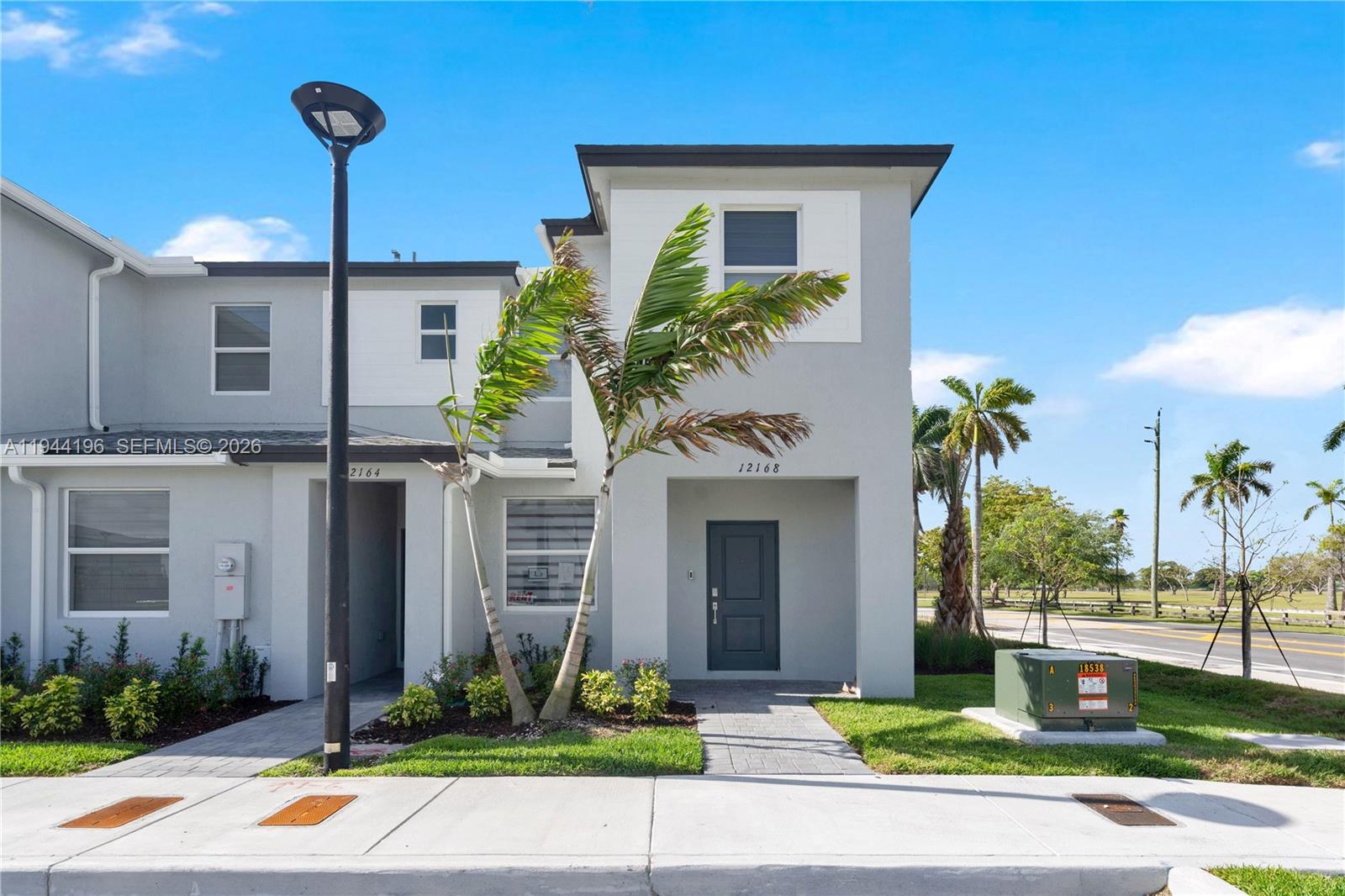 12168 Southwest 268th Street Homestead, FL 33032 - Photo 1 of 27 a front view of a house with garden