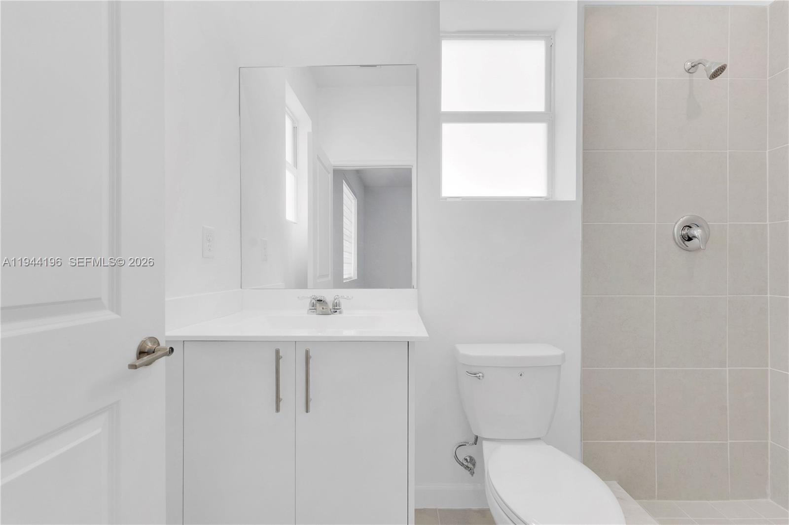 12168 Southwest 268th Street Homestead, FL 33032 - Photo 16 of 27 a bathroom with a toilet a sink a mirror and shower