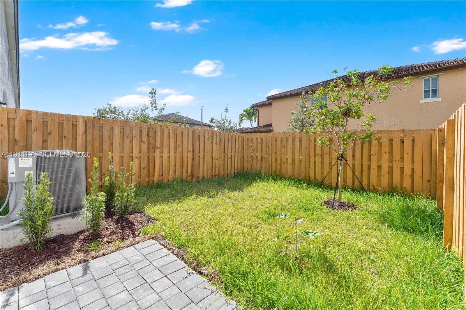 12168 Southwest 268th Street Homestead, FL 33032 - Photo 19 of 27 a backyard of a house with plants and garden