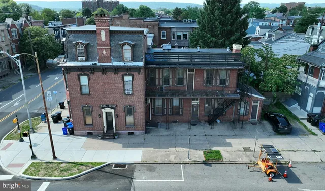 a view of house with outdoor space and sitting area