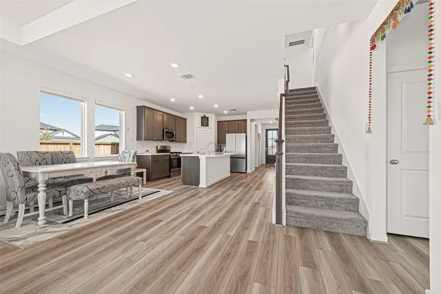 a view of kitchen with furniture and wooden floor
