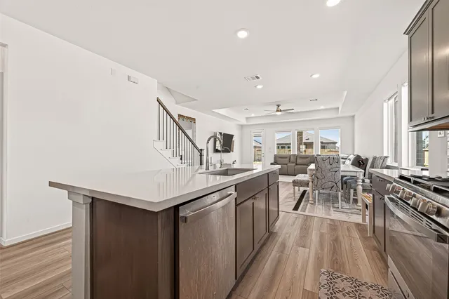 a kitchen with lots of counter top space and stainless steel appliances
