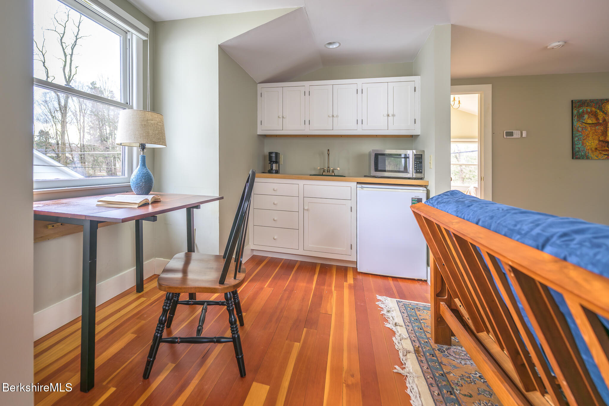 11 Sergeant Street Stockbridge, MA 01262 - Photo 47 of 52 a kitchen with kitchen island granite countertop wooden floors and white appliances