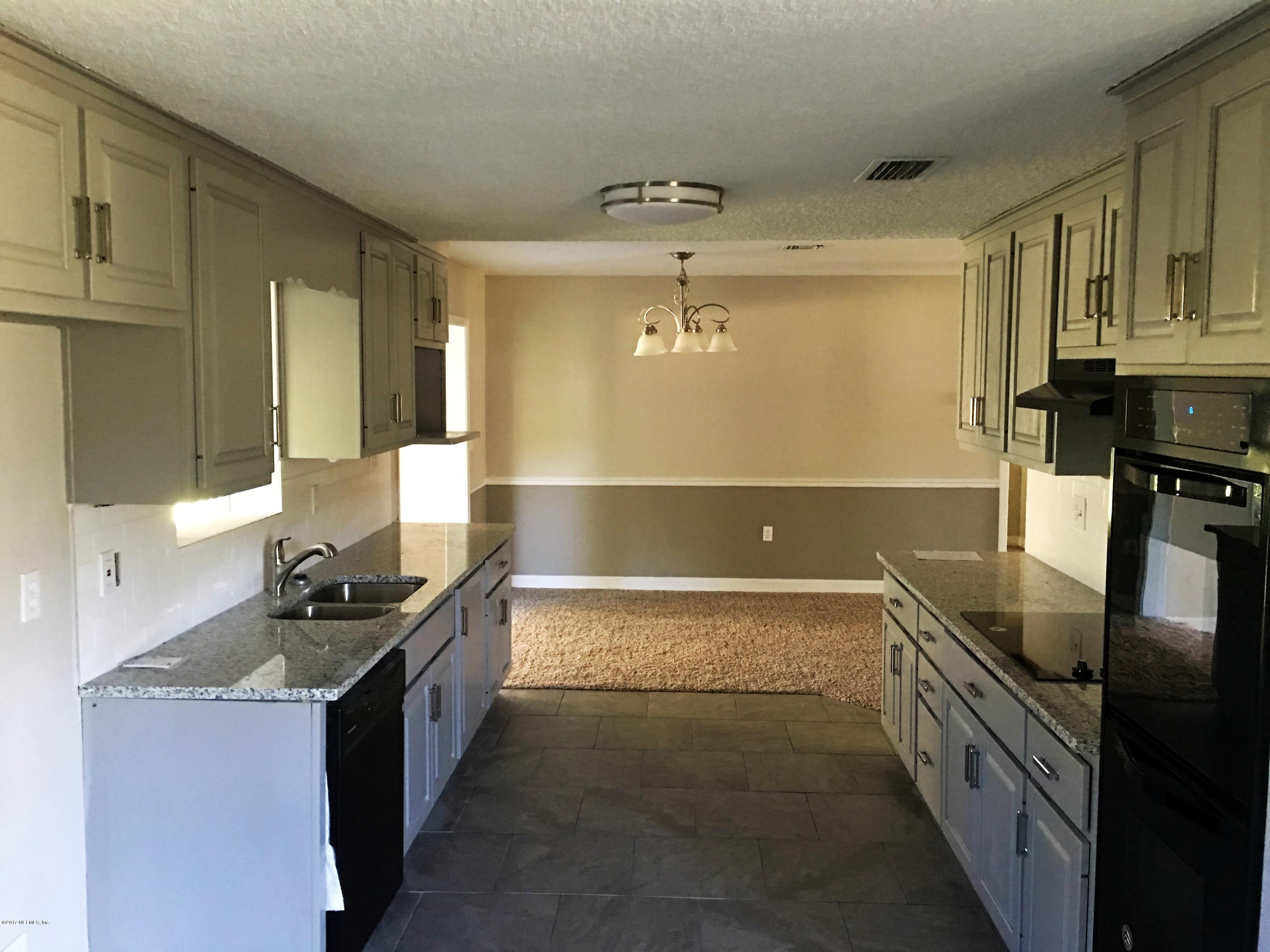 43663 Ratliff Road Callahan, FL 32011 - Photo 15 of 36 a kitchen with stainless steel appliances granite countertop a sink and stove