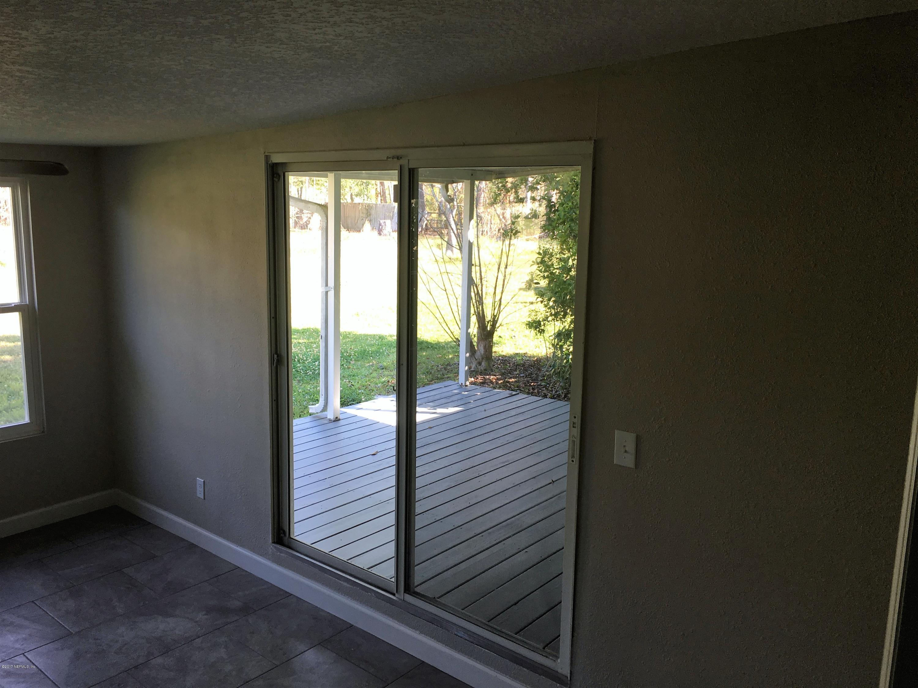 43663 Ratliff Road Callahan, FL 32011 - Photo 18 of 36 a view of a room with wooden floor and windows
