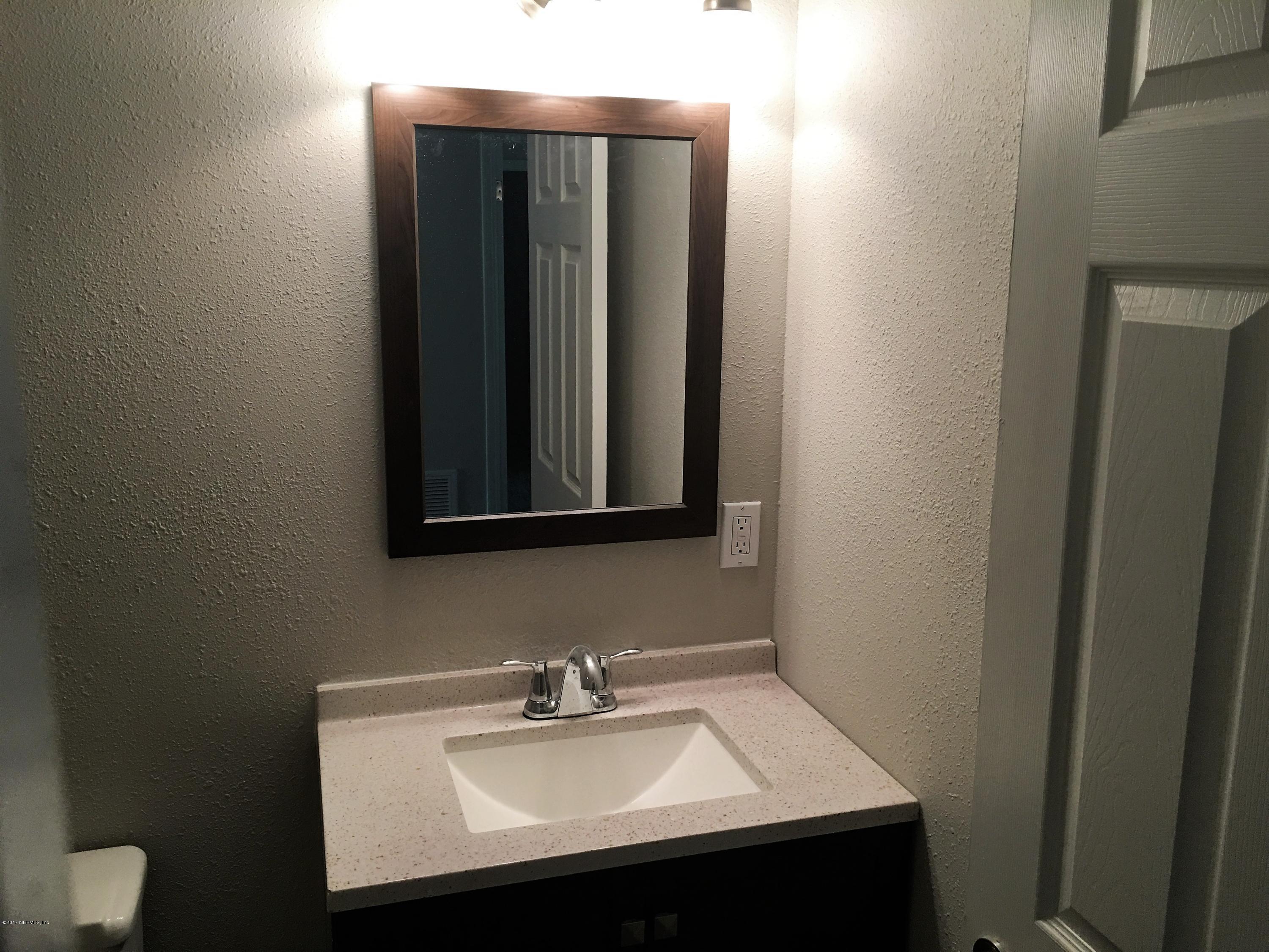 43663 Ratliff Road Callahan, FL 32011 - Photo 22 of 36 a bathroom with a sink and a mirror