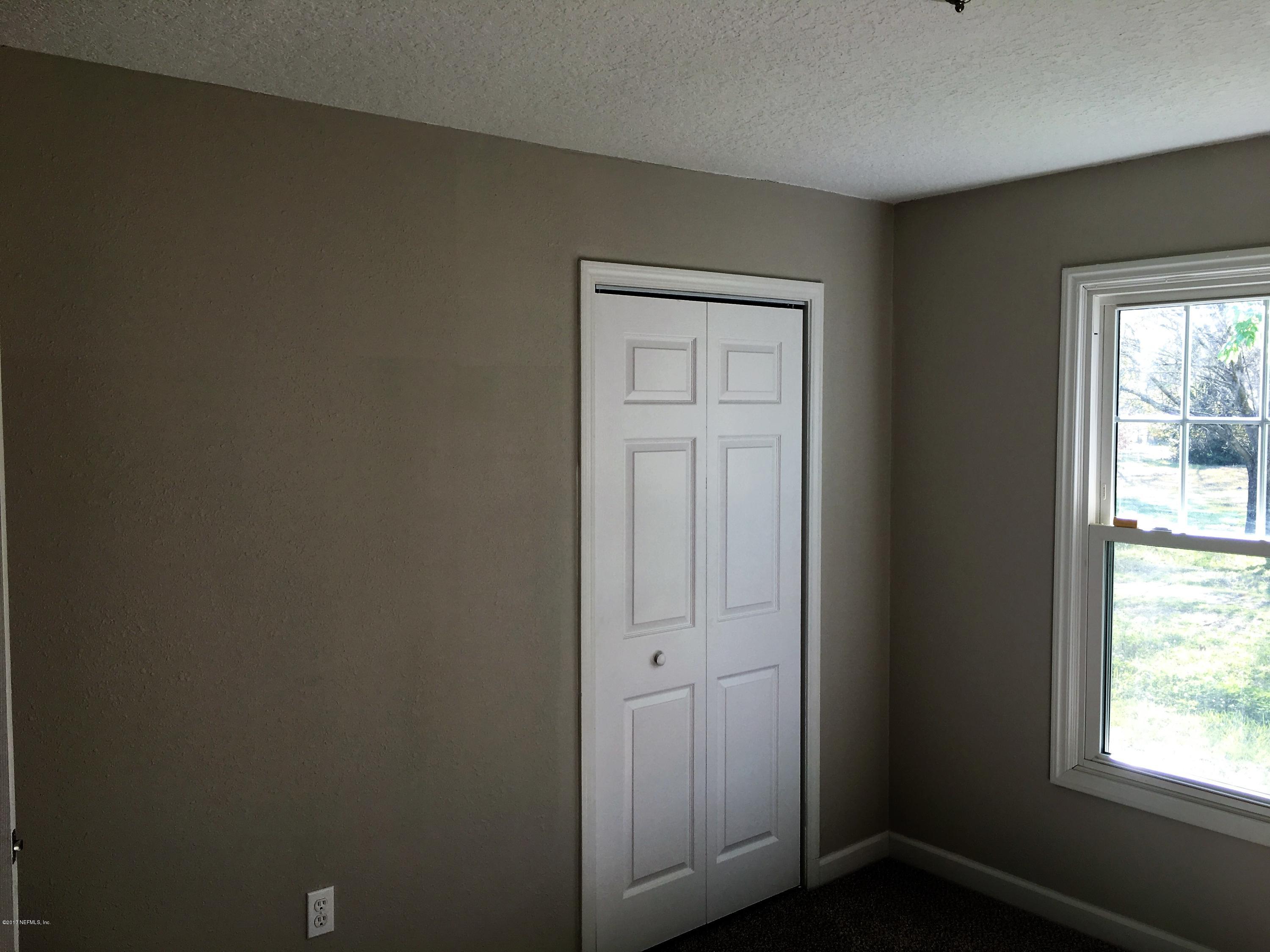 43663 Ratliff Road Callahan, FL 32011 - Photo 24 of 36 an empty room with windows and closet