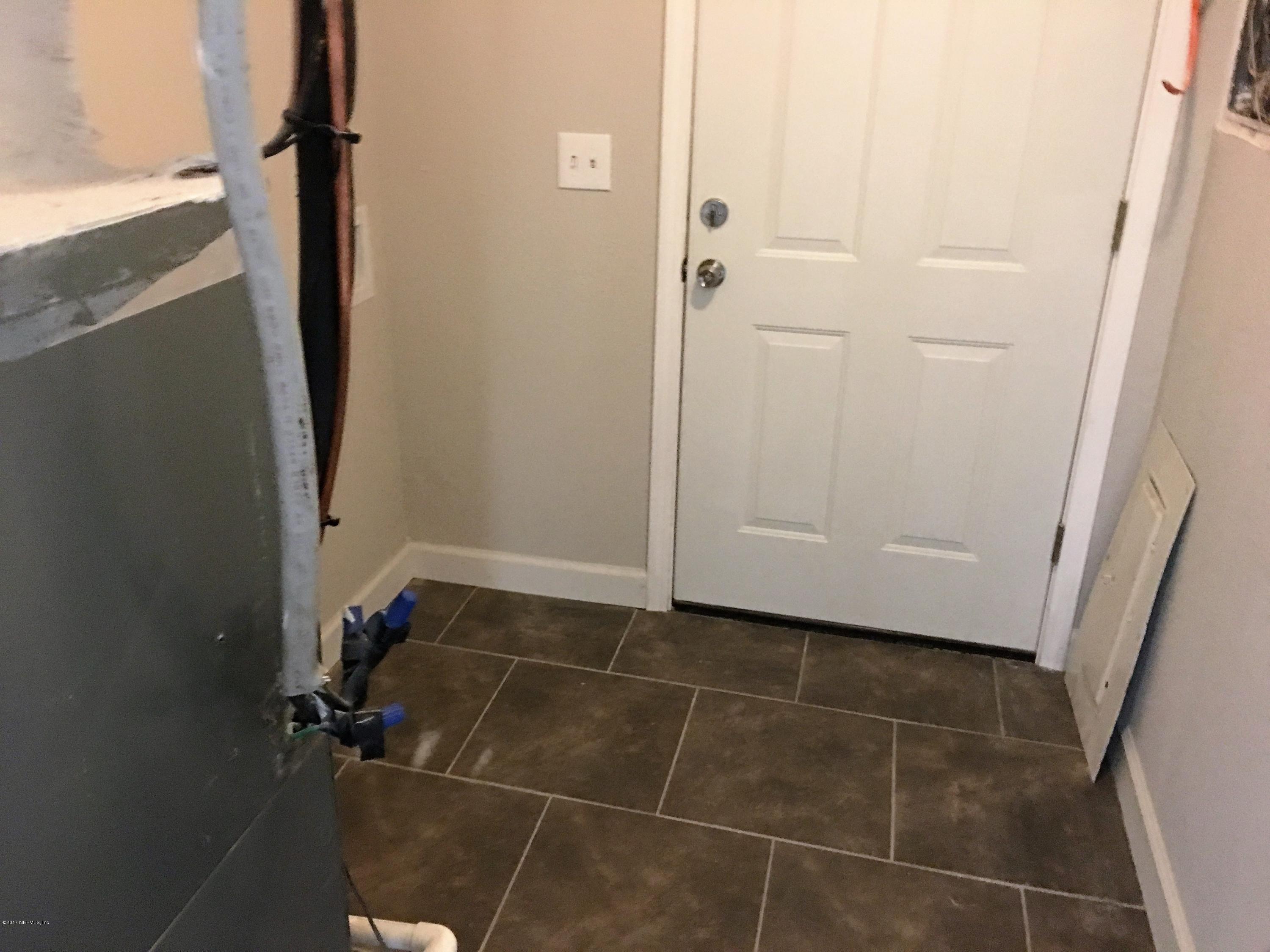 43663 Ratliff Road Callahan, FL 32011 - Photo 27 of 36 a bathroom with a window and a shower