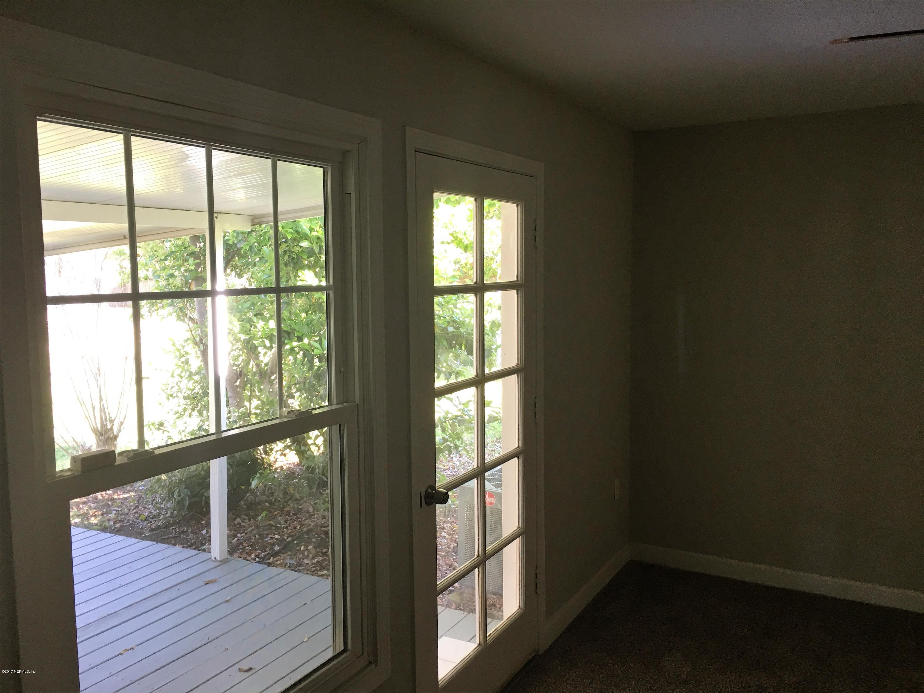 43663 Ratliff Road Callahan, FL 32011 - Photo 30 of 36 a view of an empty room with wooden floor and a window