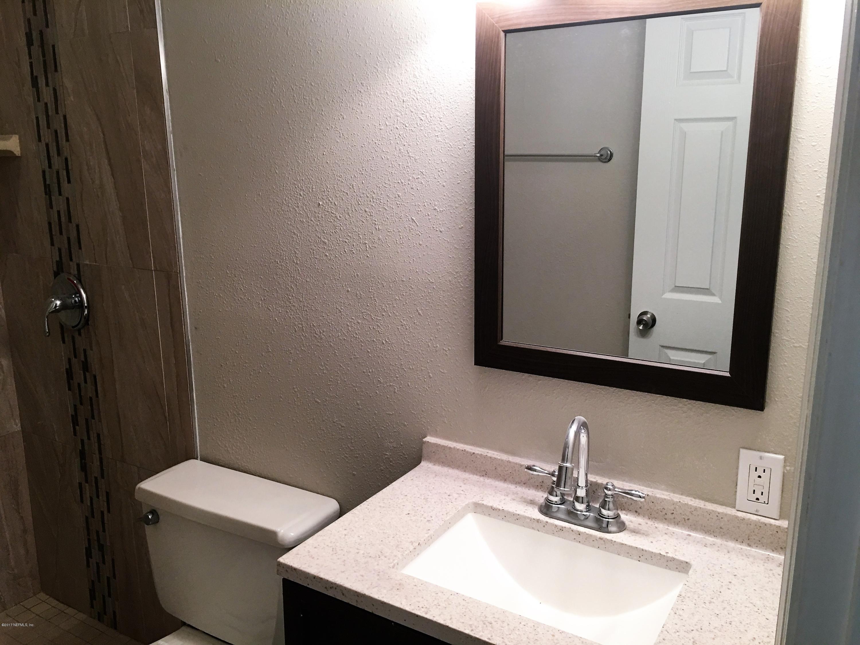 43663 Ratliff Road Callahan, FL 32011 - Photo 32 of 36 a bathroom with a sink toilet and mirror