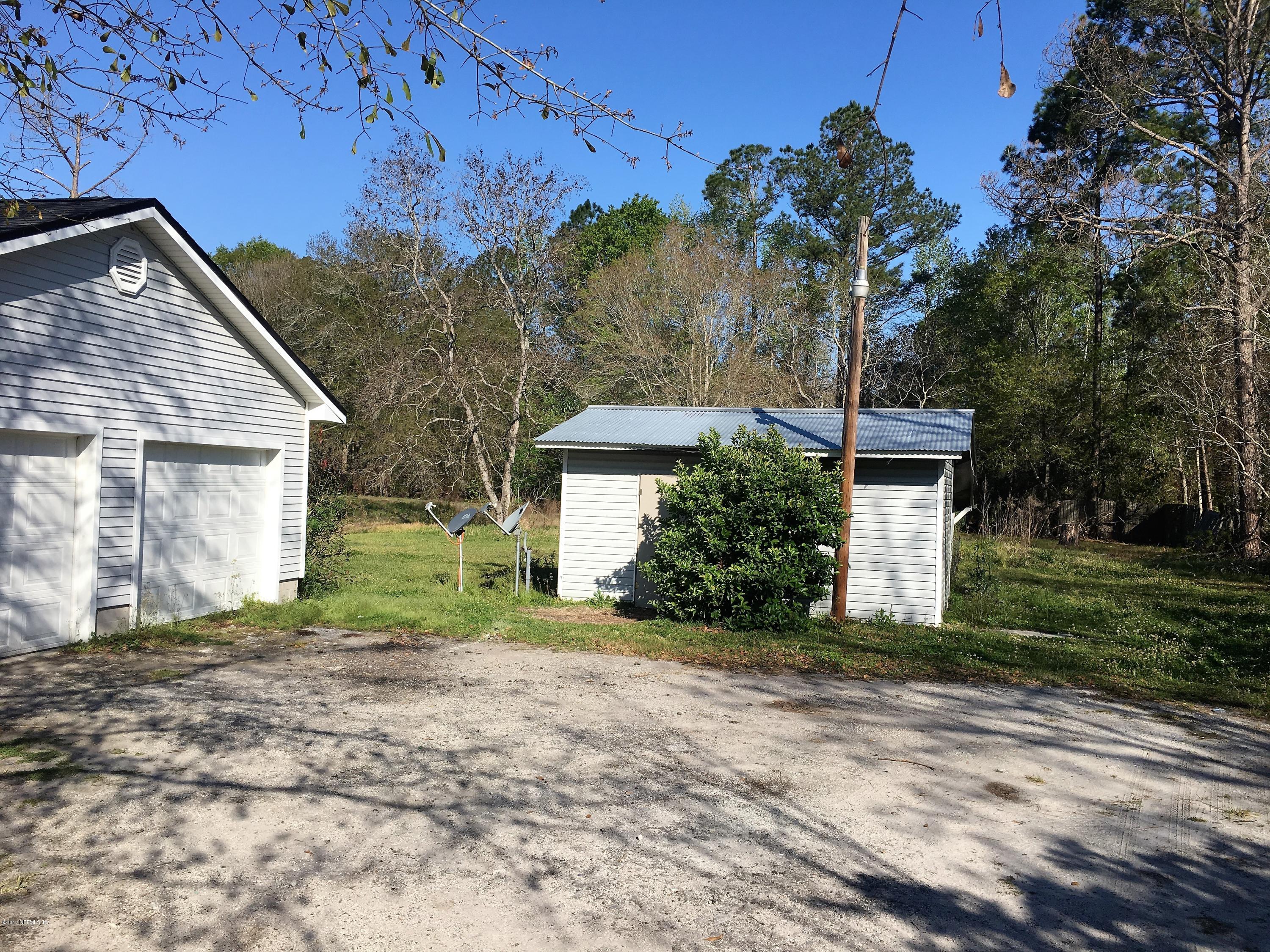 43663 Ratliff Road Callahan, FL 32011 - Photo 5 of 36 a view of a house with a yard and tree s