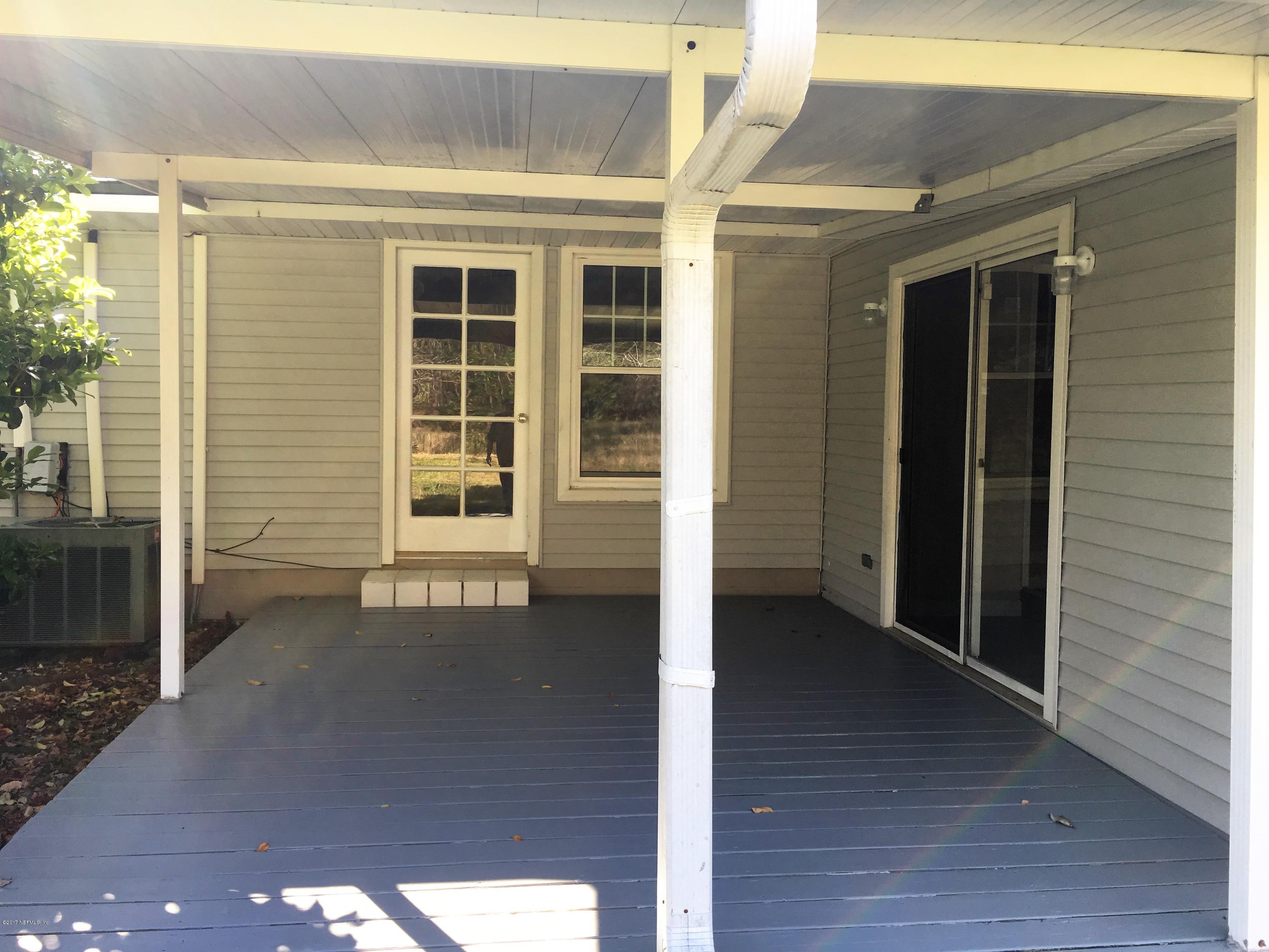 43663 Ratliff Road Callahan, FL 32011 - Photo 9 of 36 a view of a porch with wooden floor and a window