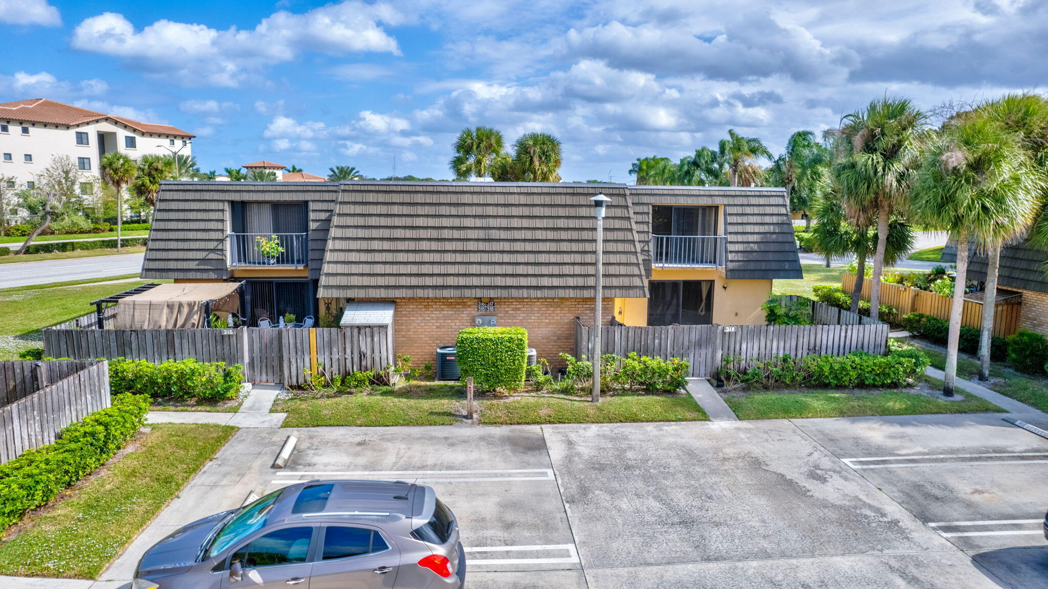 318 3rd Way West Palm Beach, FL 33407 - Photo 20 of 26 a front view of a house with a yard and potted plants