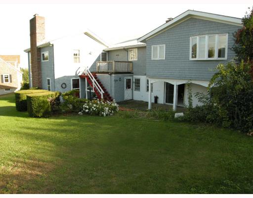 40 Robin Road Portsmouth, RI 02871 - Photo 12 of 12 Exterior Back. The lower level features sliding doors out to the patio, and there is a nice wood deck off the second story Great Room.