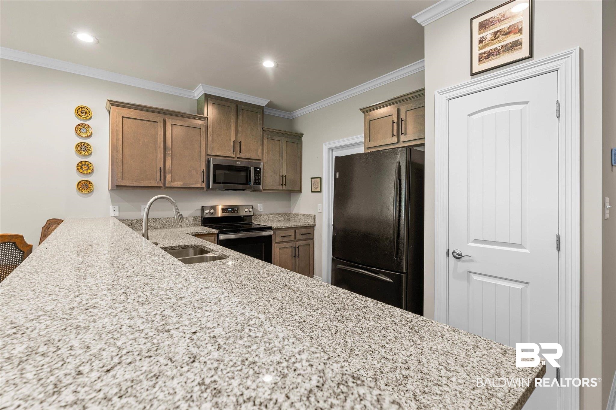 1101 Pinemont Drive Mobile, AL 36609 - Photo 6 of 18 Kitchen featuring light stone counters, a sink, stainless steel appliances, a peninsula, and ornamental molding