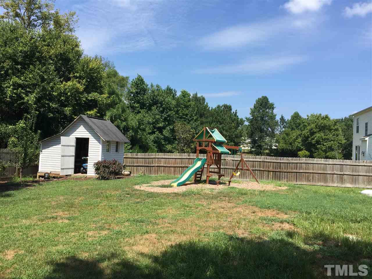 4909 Cardinal Grove Boulevard Raleigh, NC 27616 - Photo 4 of 14 a swimming pool with lots of tress in front of it