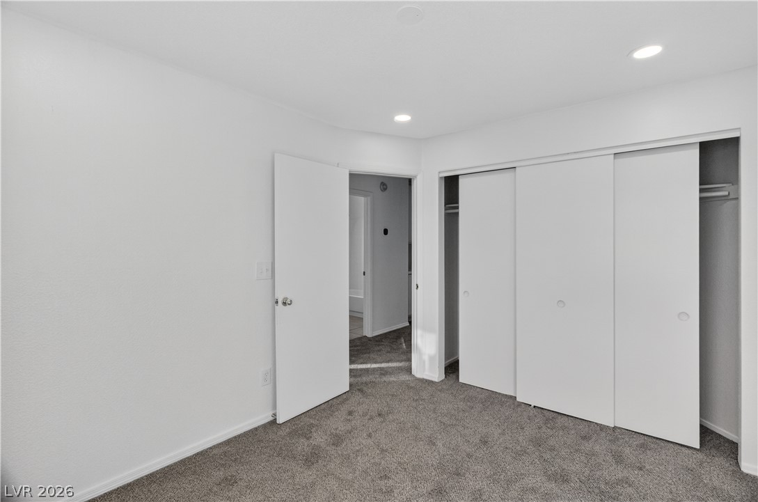 3156 Terrace View Drive Laughlin, NV 89029 - Photo 41 of 94 Step into a well-lit bedroom featuring practical sliding closet doors and plush carpeting.
