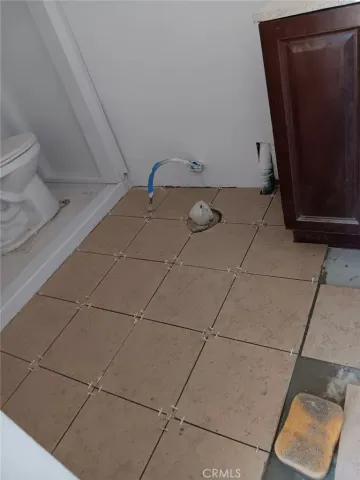 a view of a small space with wooden floor and a sink