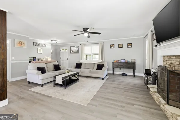 a living room with furniture and a flat screen tv