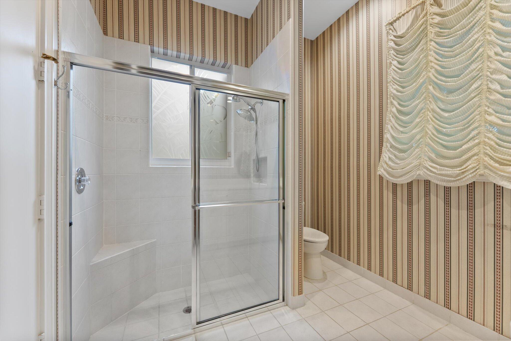 7081 Mallorca Crescent Boca Raton, FL 33433 - Photo 15 of 26 a bathroom with a bathtub and a shower