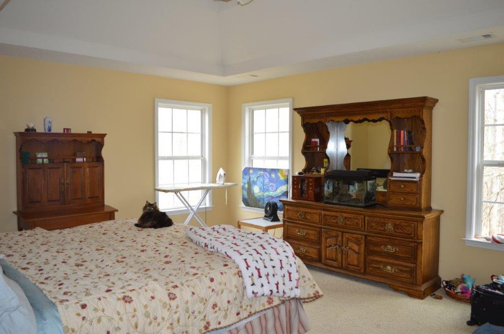 163 Oliver Greene Road Gray, GA 31032 - Photo 12 of 19 a bedroom with a bed and a dresser