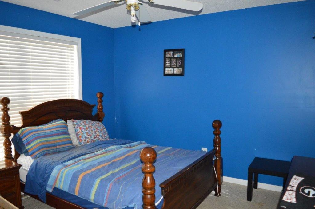 163 Oliver Greene Road Gray, GA 31032 - Photo 17 of 19 a bedroom with a bed and a desk
