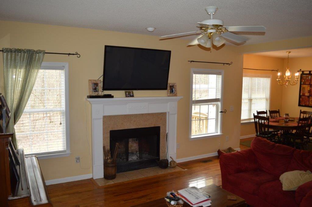 163 Oliver Greene Road Gray, GA 31032 - Photo 6 of 19 a living room with furniture a flat screen tv and a fireplace