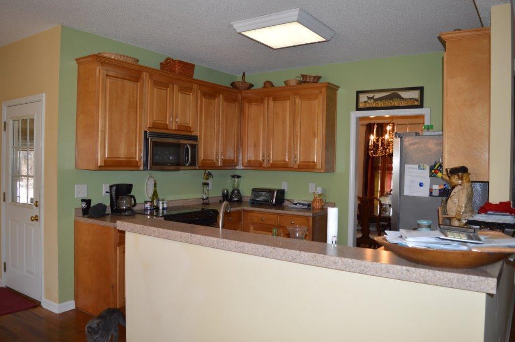 163 Oliver Greene Road Gray, GA 31032 - Photo 7 of 19 a kitchen with stainless steel appliances granite countertop a sink and a microwave
