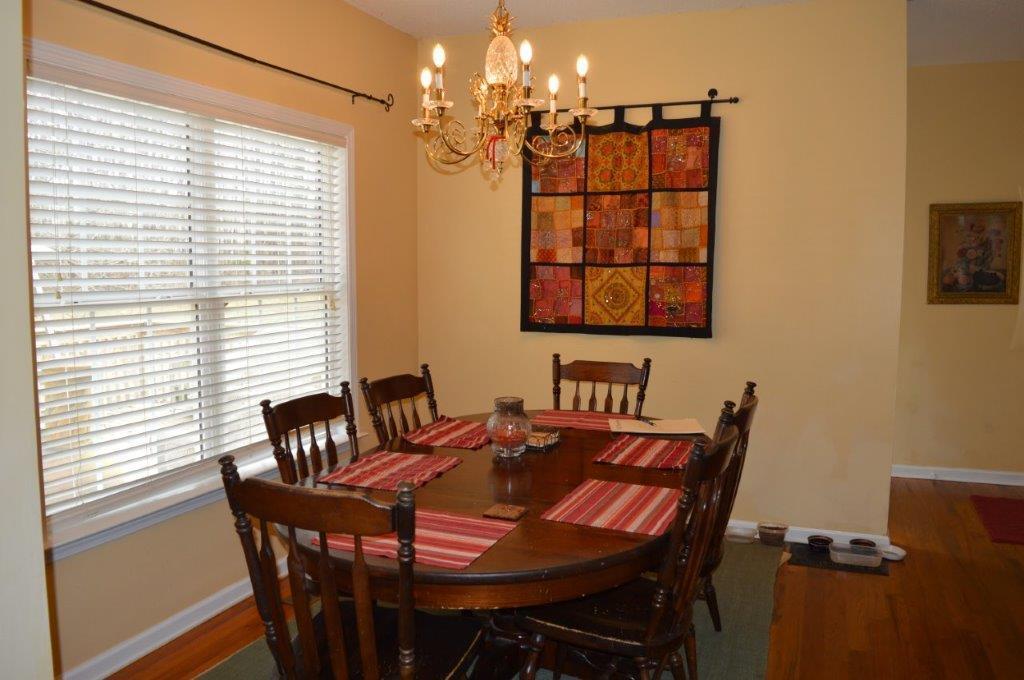 163 Oliver Greene Road Gray, GA 31032 - Photo 8 of 19 a view of a dining room with furniture and chandelier