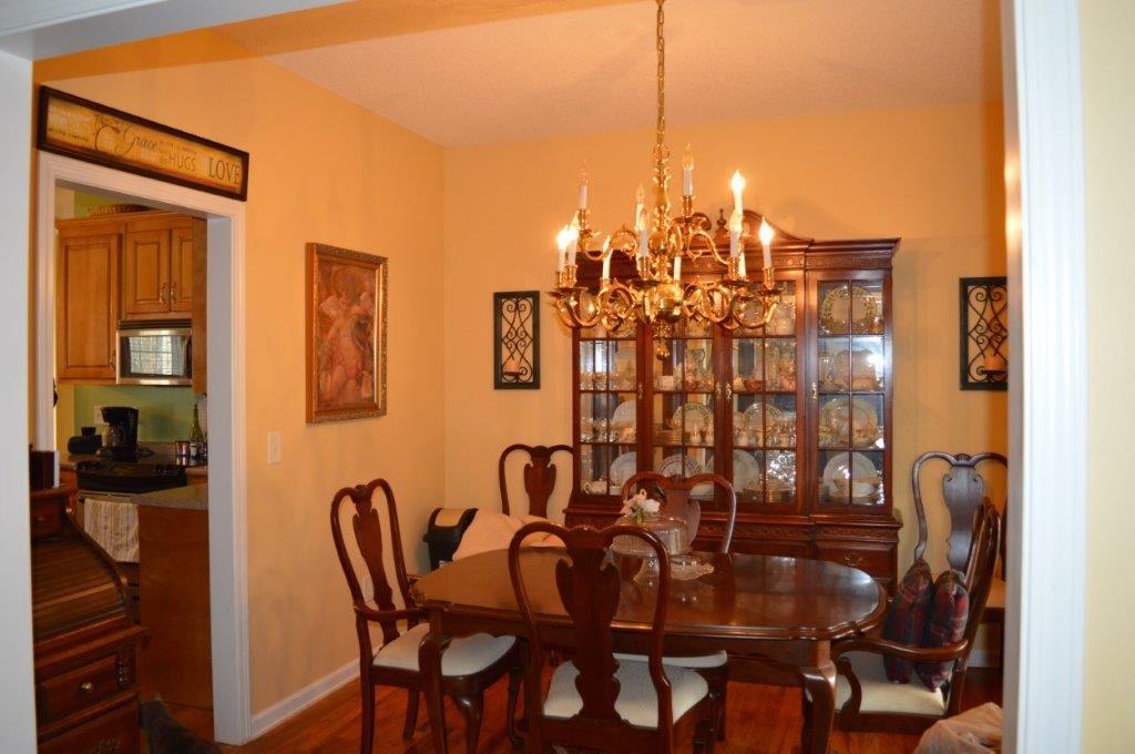 163 Oliver Greene Road Gray, GA 31032 - Photo 9 of 19 a view of a dining room with furniture and chandelier