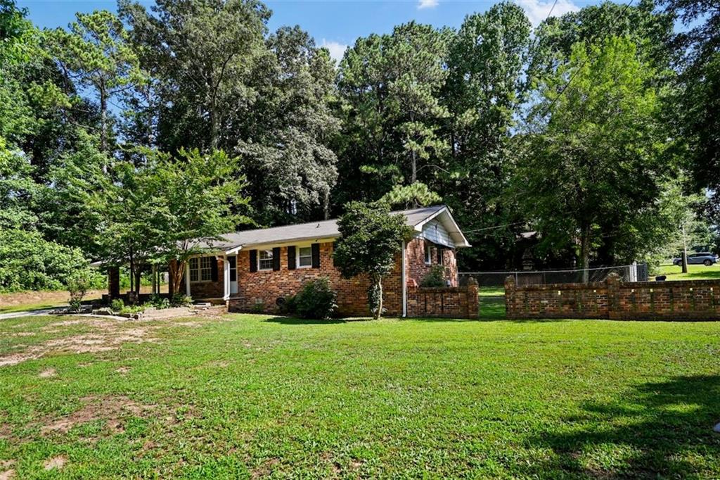 a front view of house with yard and green space