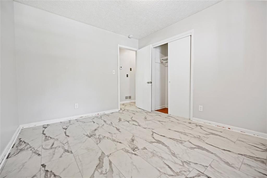 7039 Rockbridge Road Southwest Stone Mountain, GA 30087 - Photo 13 of 28 a view of a big room with wooden floor