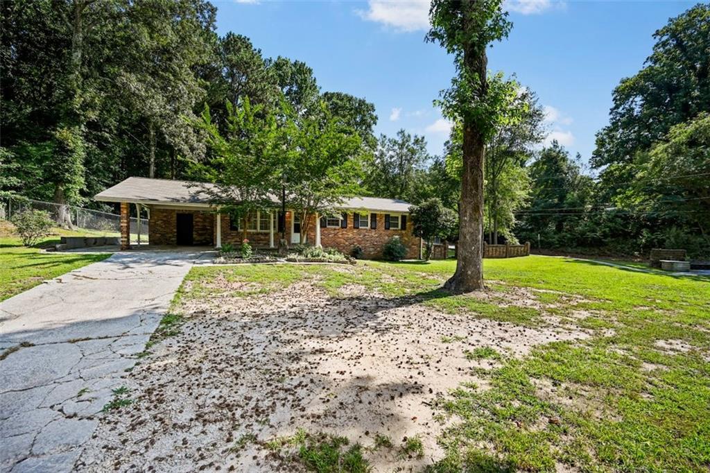 7039 Rockbridge Road Southwest Stone Mountain, GA 30087 - Photo 2 of 28 a view of a house with a yard