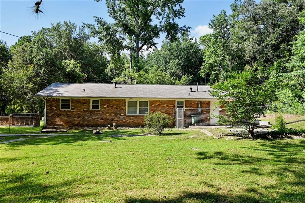 7039 Rockbridge Road Southwest Stone Mountain, GA 30087 - Photo 27 of 28 a front view of a house with garden