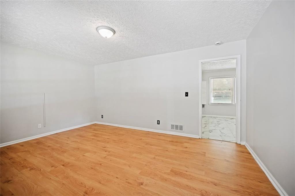 7039 Rockbridge Road Southwest Stone Mountain, GA 30087 - Photo 4 of 28 a view of an empty room