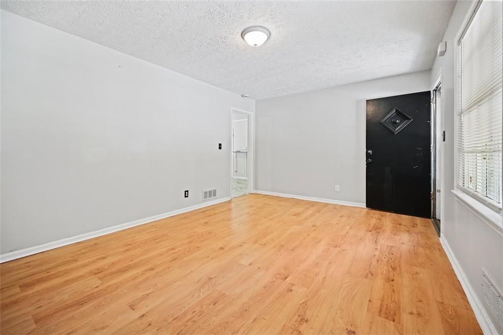 7039 Rockbridge Road Southwest Stone Mountain, GA 30087 - Photo 5 of 28 a view of an empty room