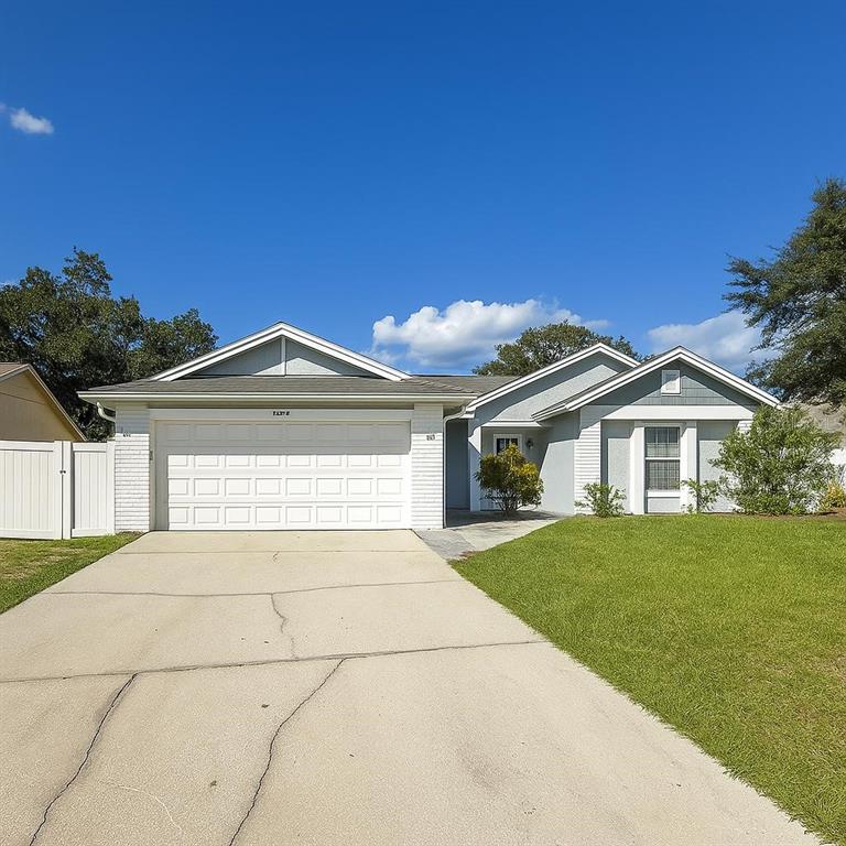 Undisclosed Address Orlando, FL 32818 - Photo 1 of 7 a front view of a house with a yard